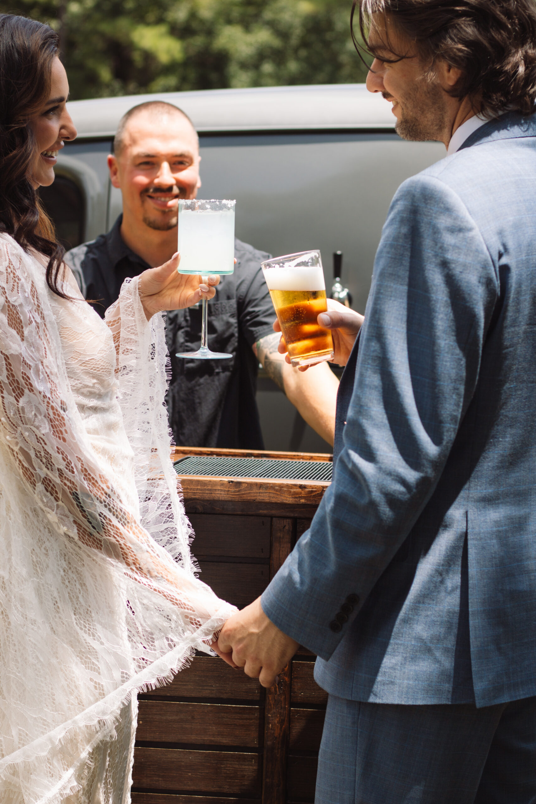 Professional bartender preparing handcrafted cocktails for wedding guests.